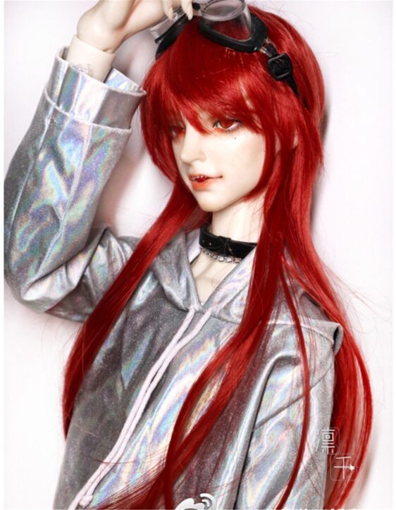 a doll with red hair and a silver jacket