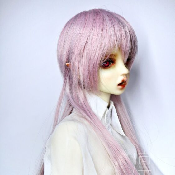 a doll with long pink hair and red eyes