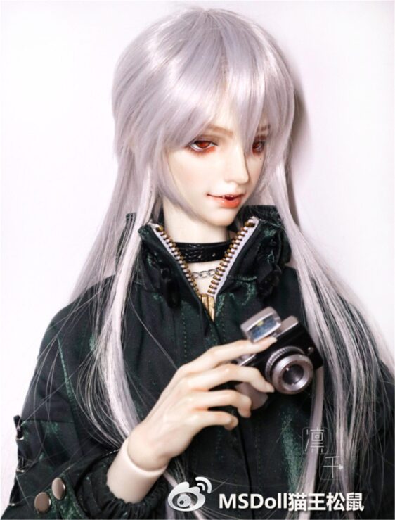 a doll holding a camera