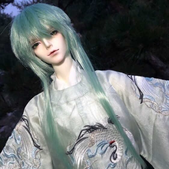 a doll with green hair and a white robe