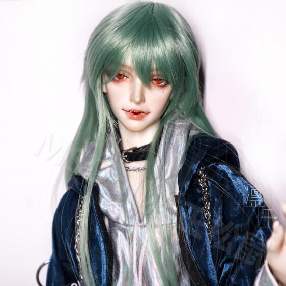 a doll with green hair and red eyes